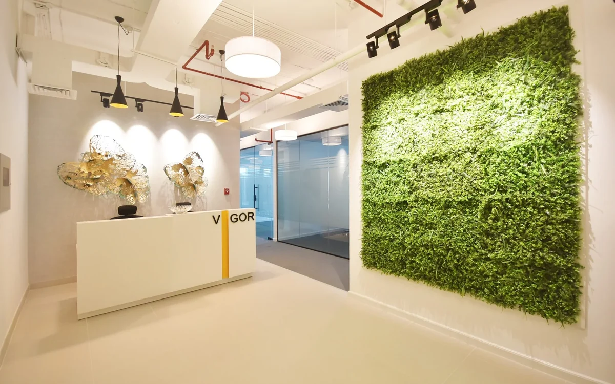 The Dzire Business Center reception in Business Bay, with the Vigor sign and living green wall
