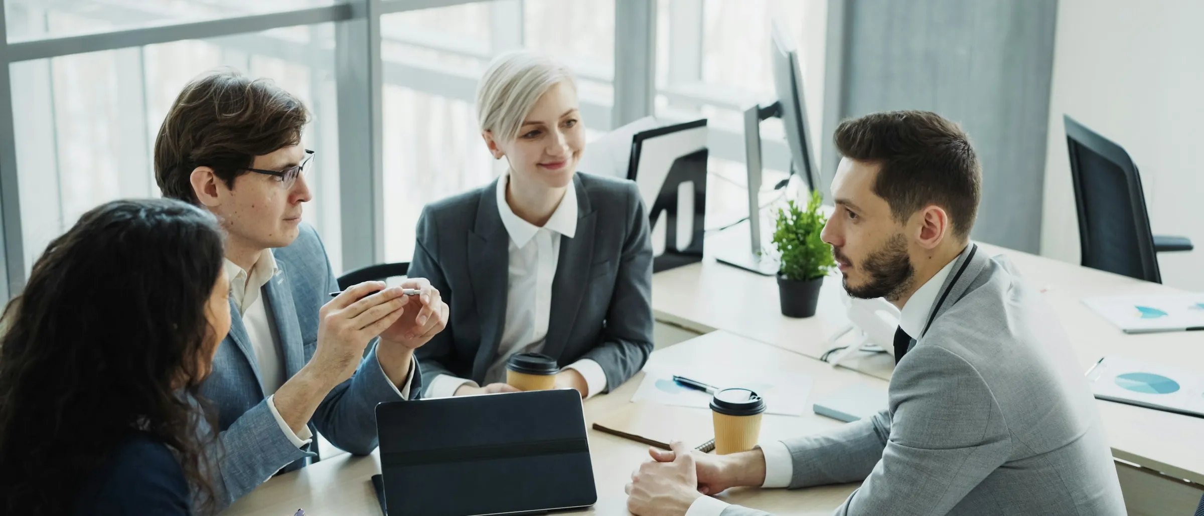 A diverse professional team working together around a table in a modern office