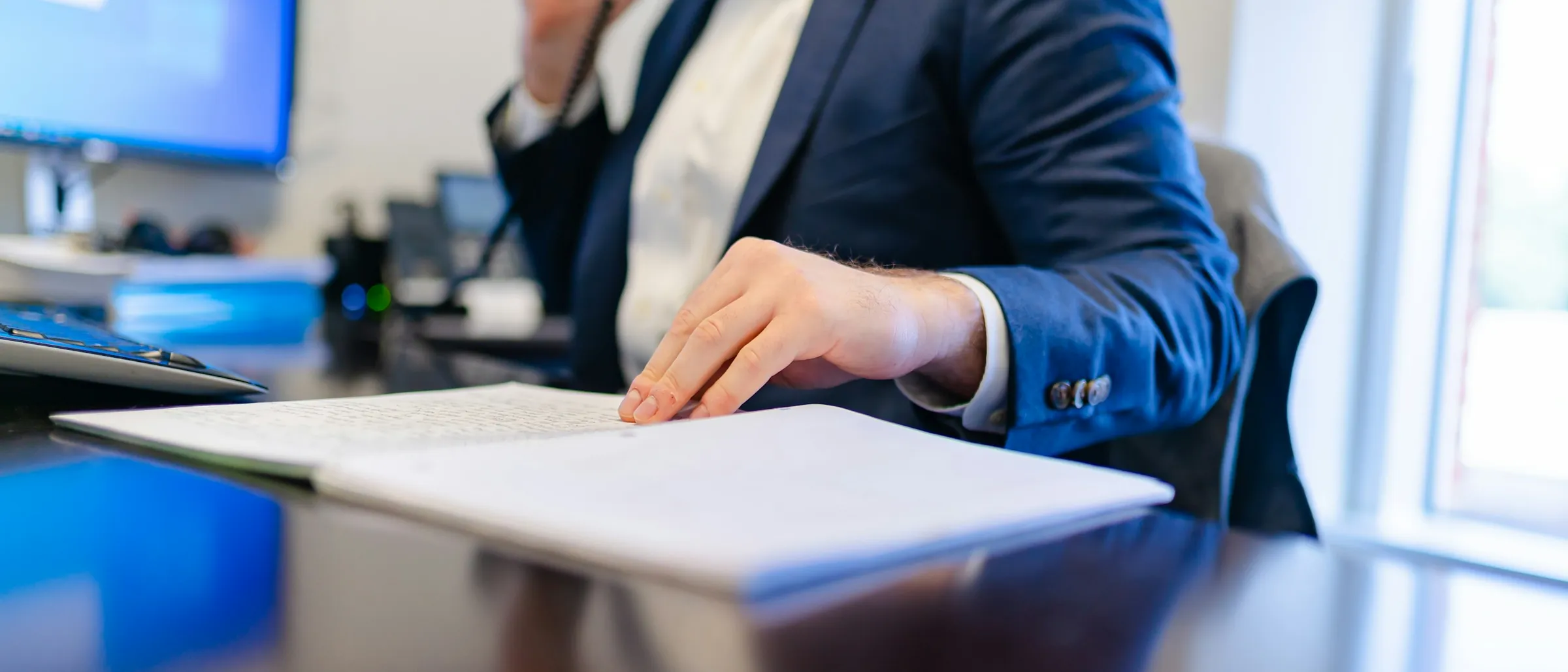 An accountant working at a desk with a laptop and notes
