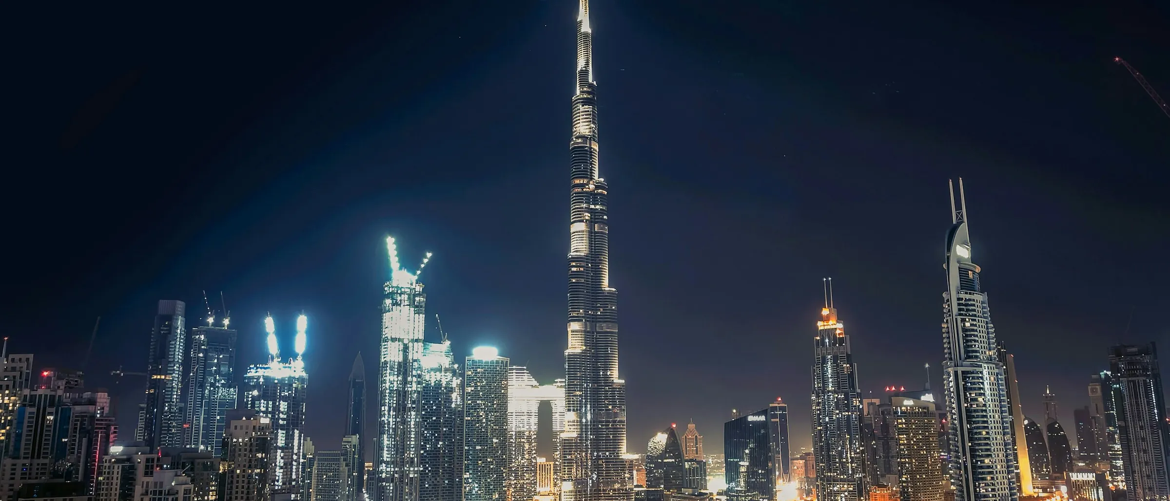 Downtown Dubai at night, the towers lit against the dark